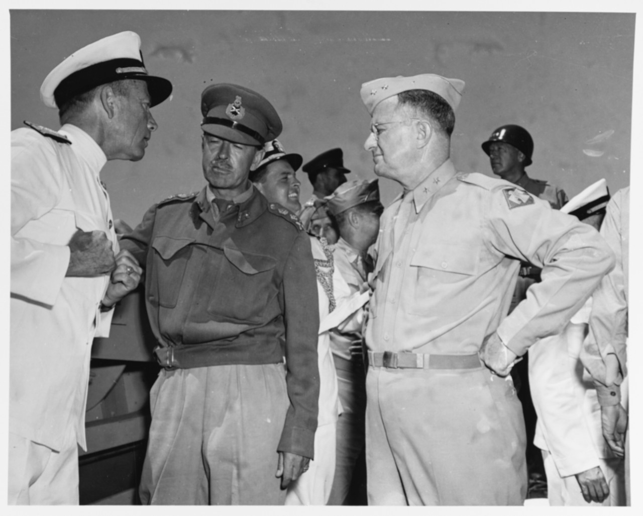 Rear Admiral Alan G. Kirk, USN, General Sir Harold Alexander British Army, and MGen. Troy H. Middleton, USA