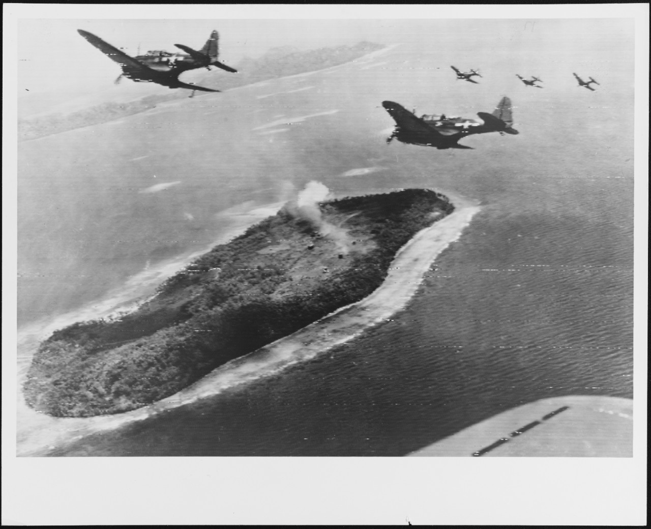 Five SBD's from a Navy carrier peel off for a strafing attack on a Japanese radio station, Ulalu Island, Truk Atoll, in the strike of April 29-30, 1944.