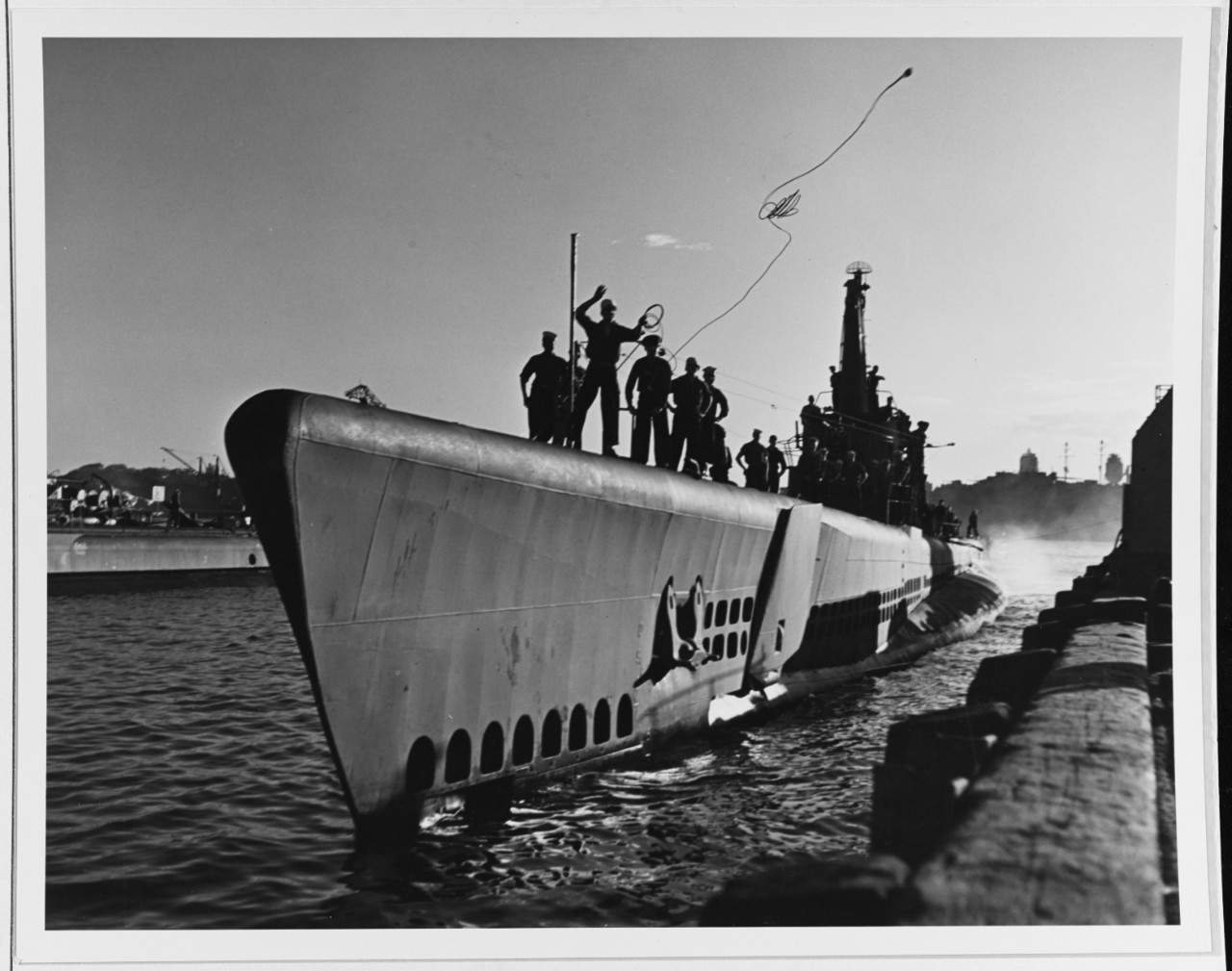 Submarine ties up at Pearl Harbor after a war patrol, 1945.