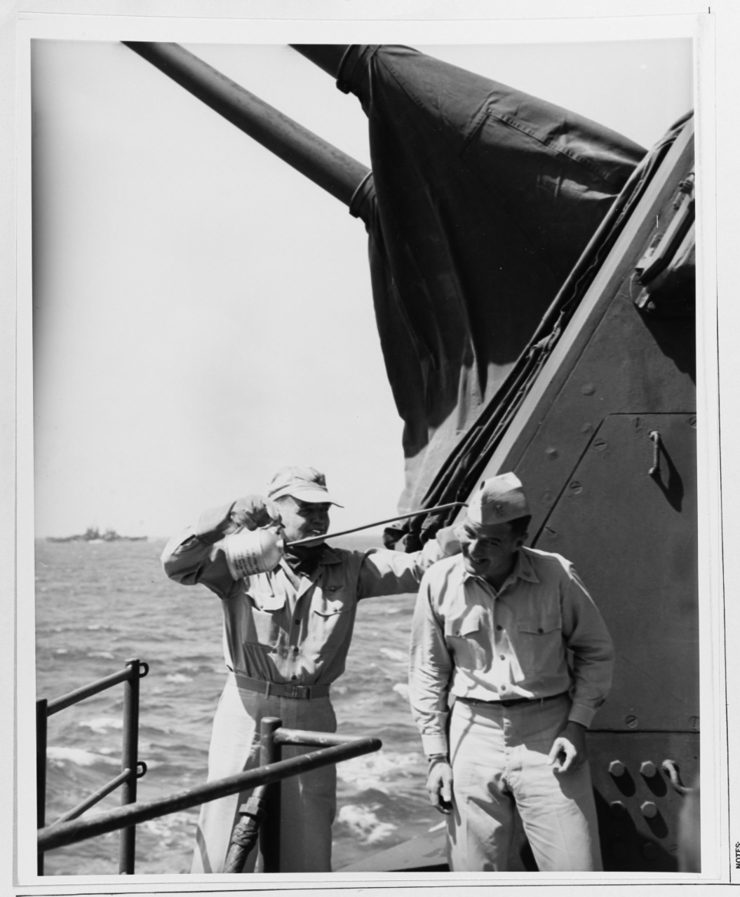 Admiral William F. Halsey , Commander Third Fleet, pretends to give Commander C. Weeks (Medical Corps) an "oiling up"