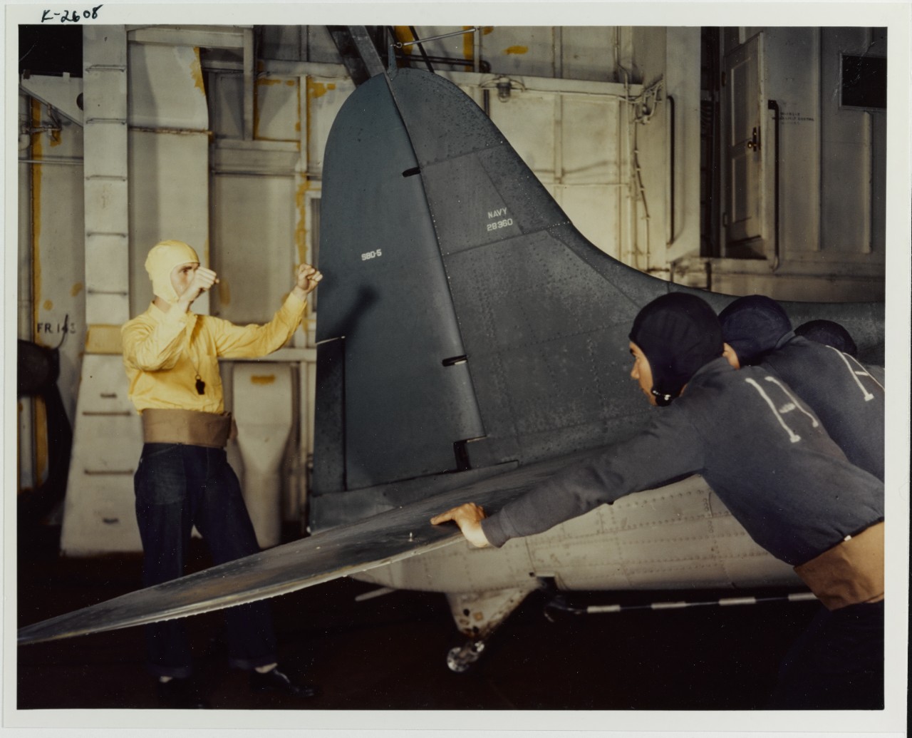 Plane director guides plane handlers, SBD-5 Bomber (BU# 28360), circa 1943-1945