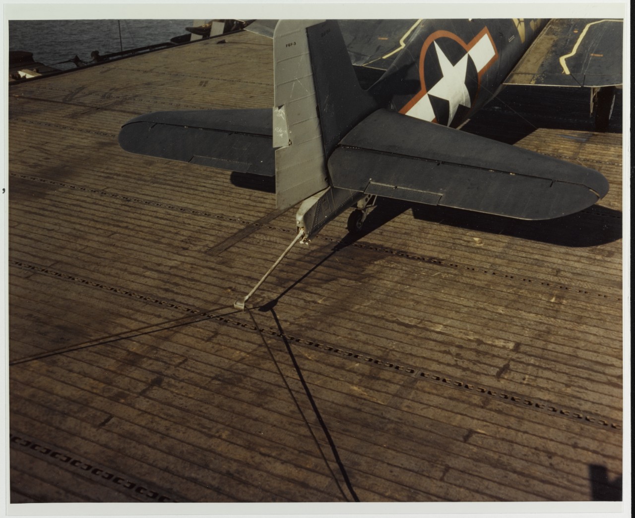 Grumman F6F-3 "Hellcat" (Bu# 26186 or 26188) makes an arrested landing on training escort carrier, circa mid 1943
