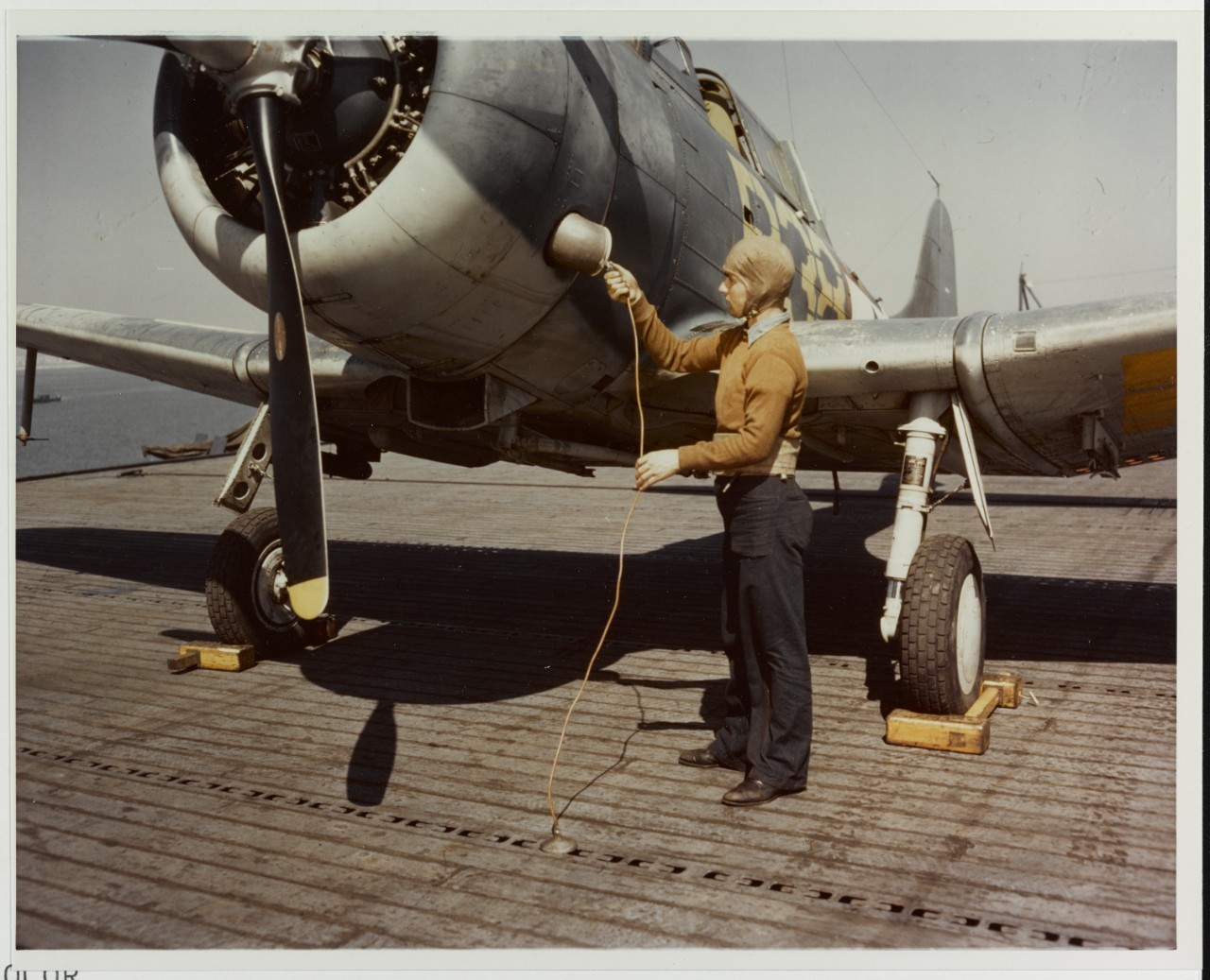 Plane captain attaches ground wire, circa 1943-1945