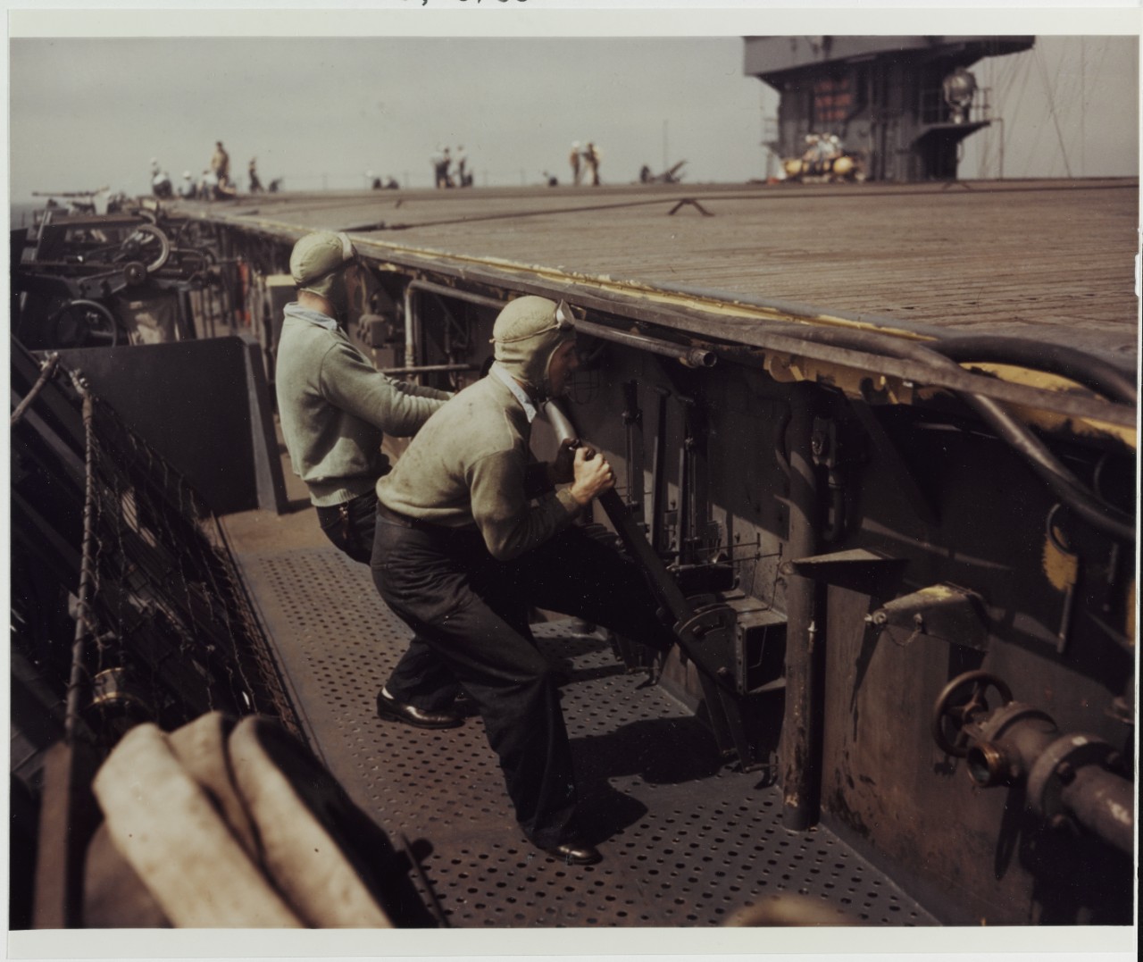 Arresting Gear Crewmen pull levers, circa 1943-1945