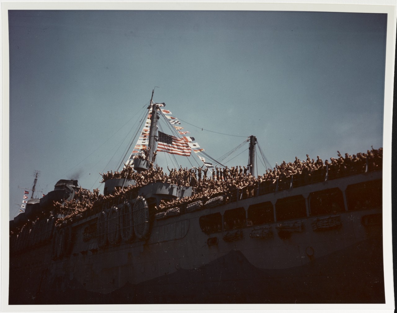 USS WEST POINT (AP-23) Flags flying and troops cheering, at New York City, 11 July 1945