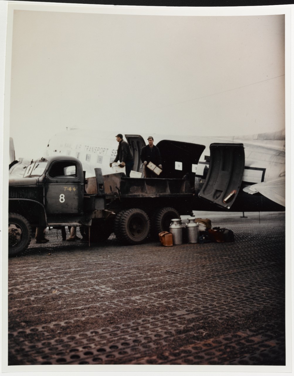 DOUGLAS R4D-6 Aircraft (Bu# 17265), of Naval Air Transport Service Squadron VR-5 being unloaded at an Alaskan airfield
