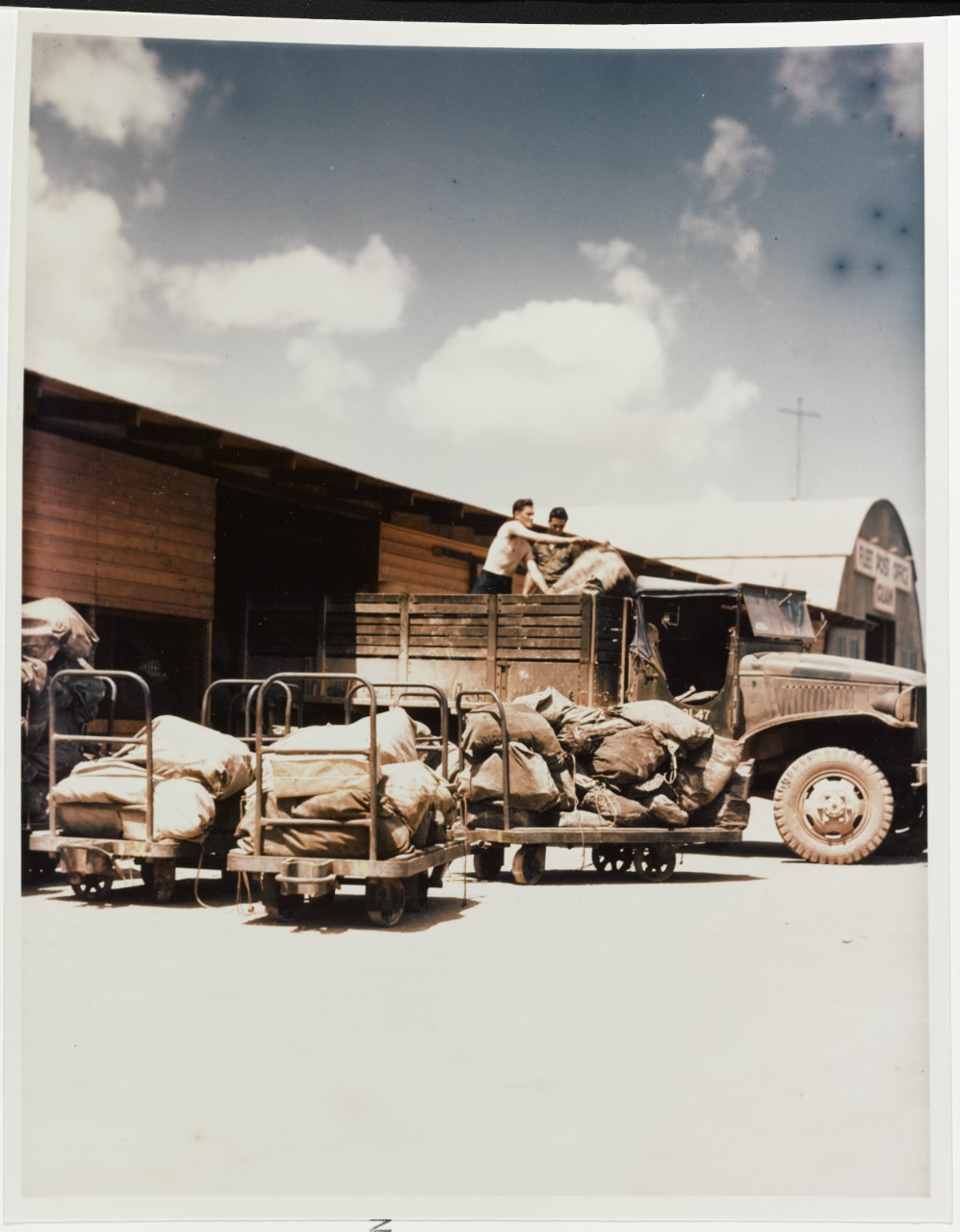 Pacific Fleet Post Office, Guam, Men unloading bags of mail, circa June 1945