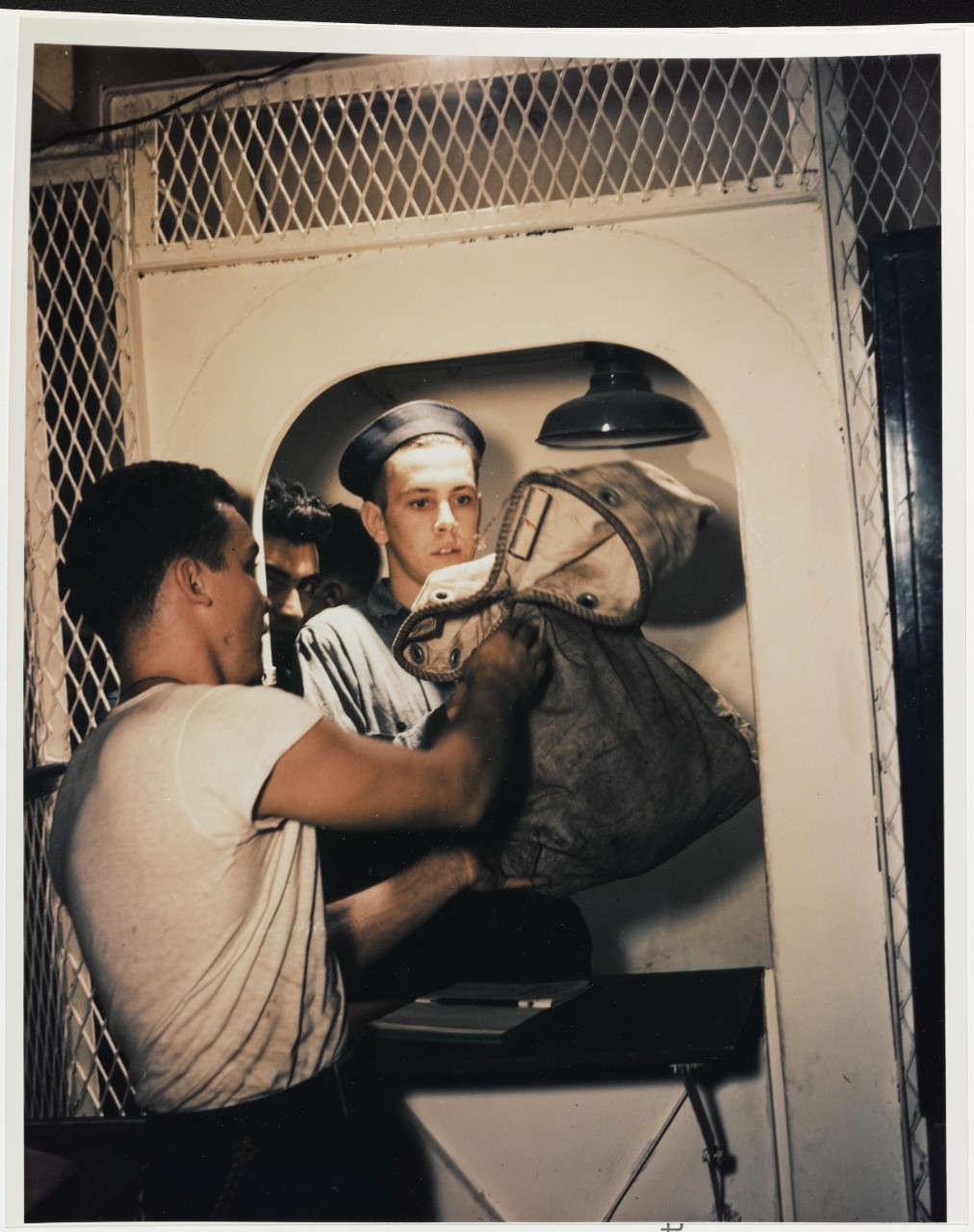 Mail Call. PRTR3c Val Gerolstein receives a sack of mail, on board a U.S. Navy ship, 1945