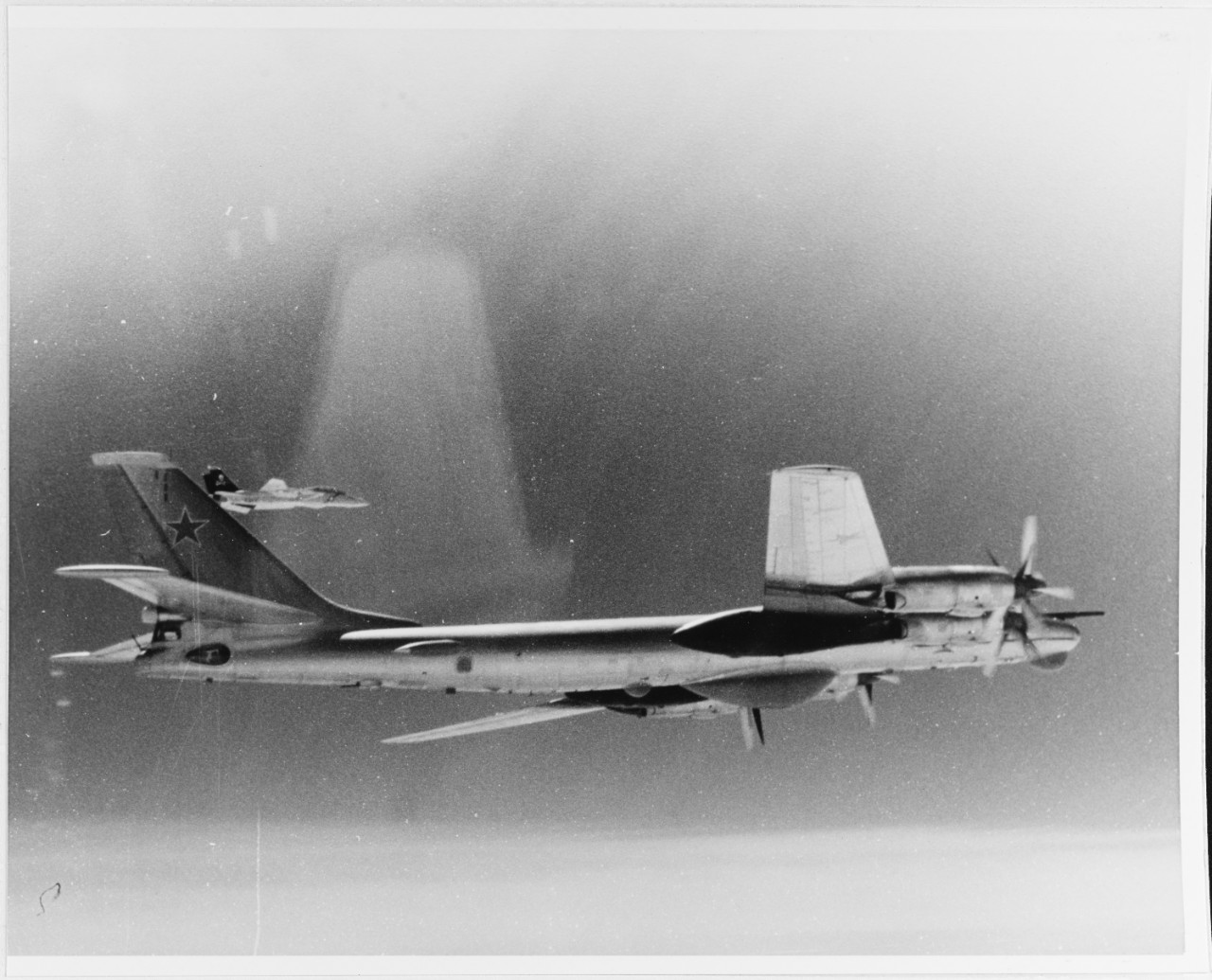 Soviet TU-95 "Bear" is escorted by a VF-84 F-14 fighter over the Mediterranean Sea