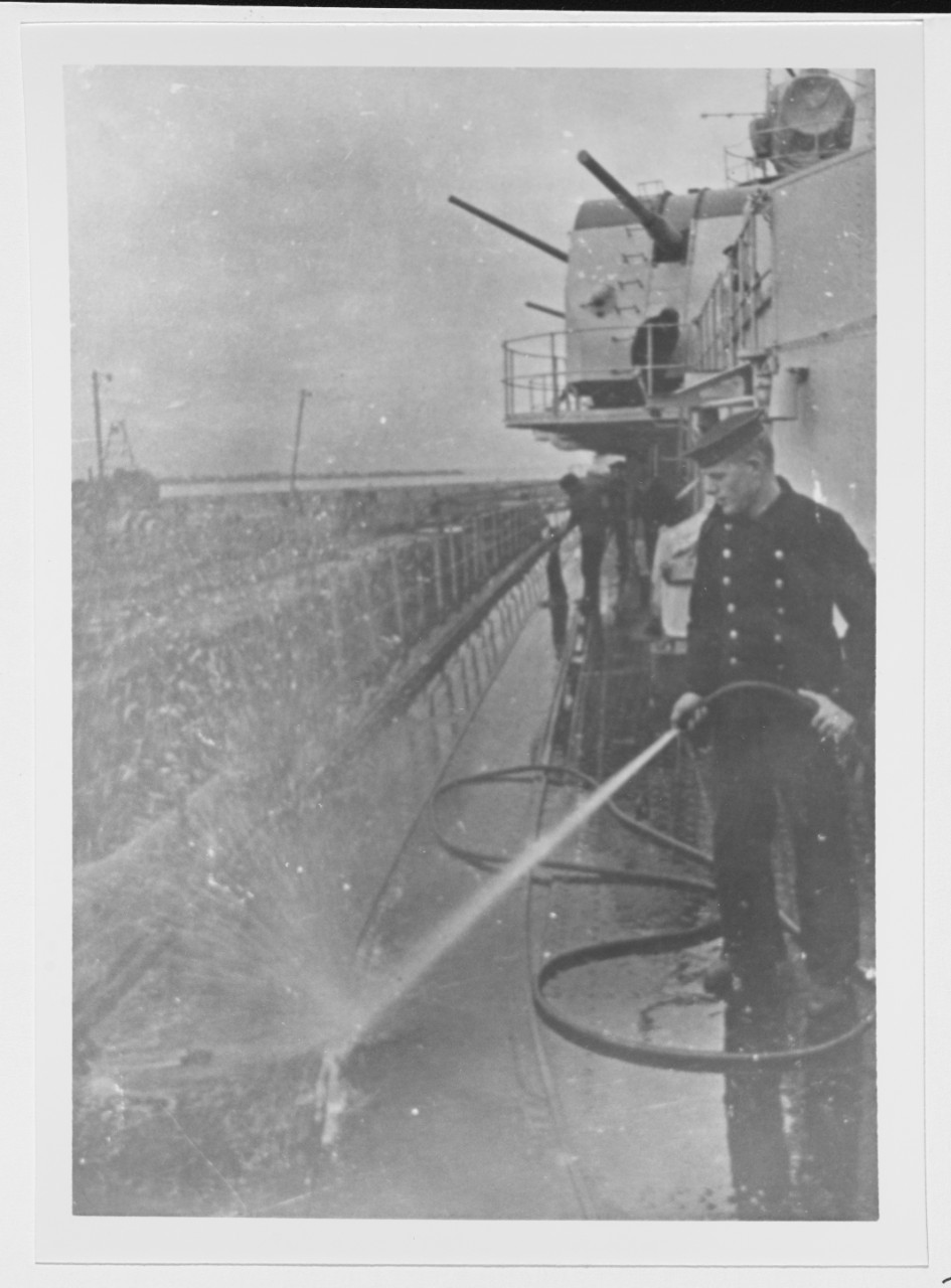 Sailor washing the deck of the Soviet cruiser MOLOTOV in April 1942.