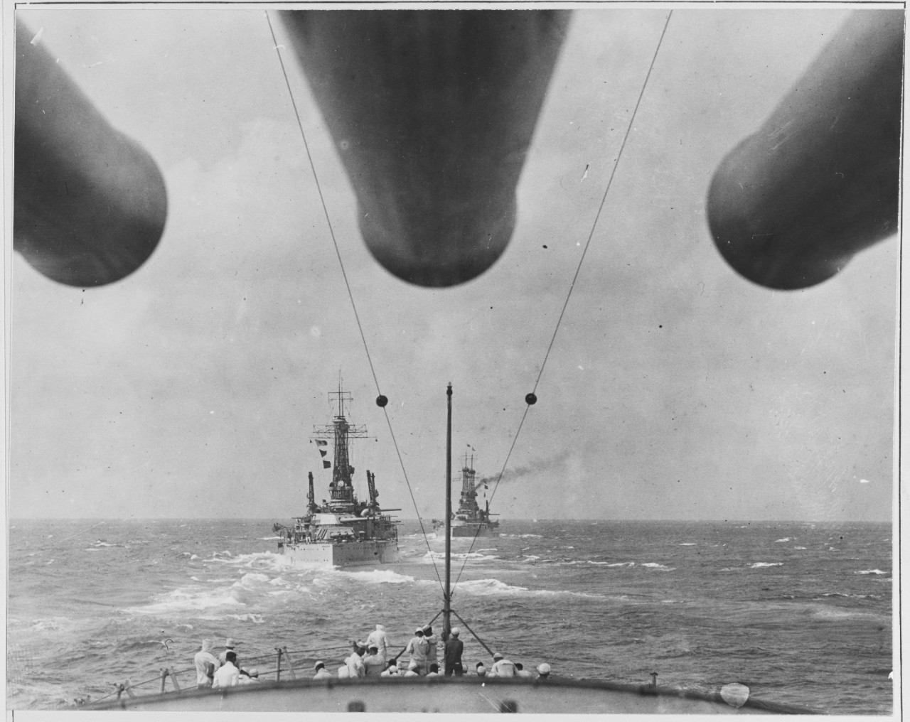 Battleship in formation taken from battleship near.
