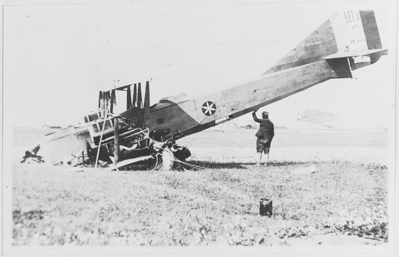 Man stands with crashed La Tour aeroplane, 1917-1919