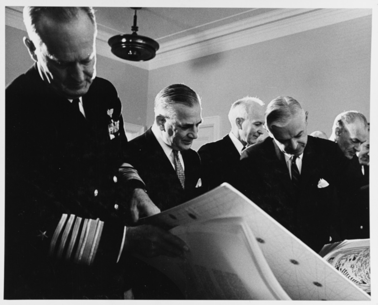 Chief of Naval operations Admiral David L. McDonald looks through Cartographic Book