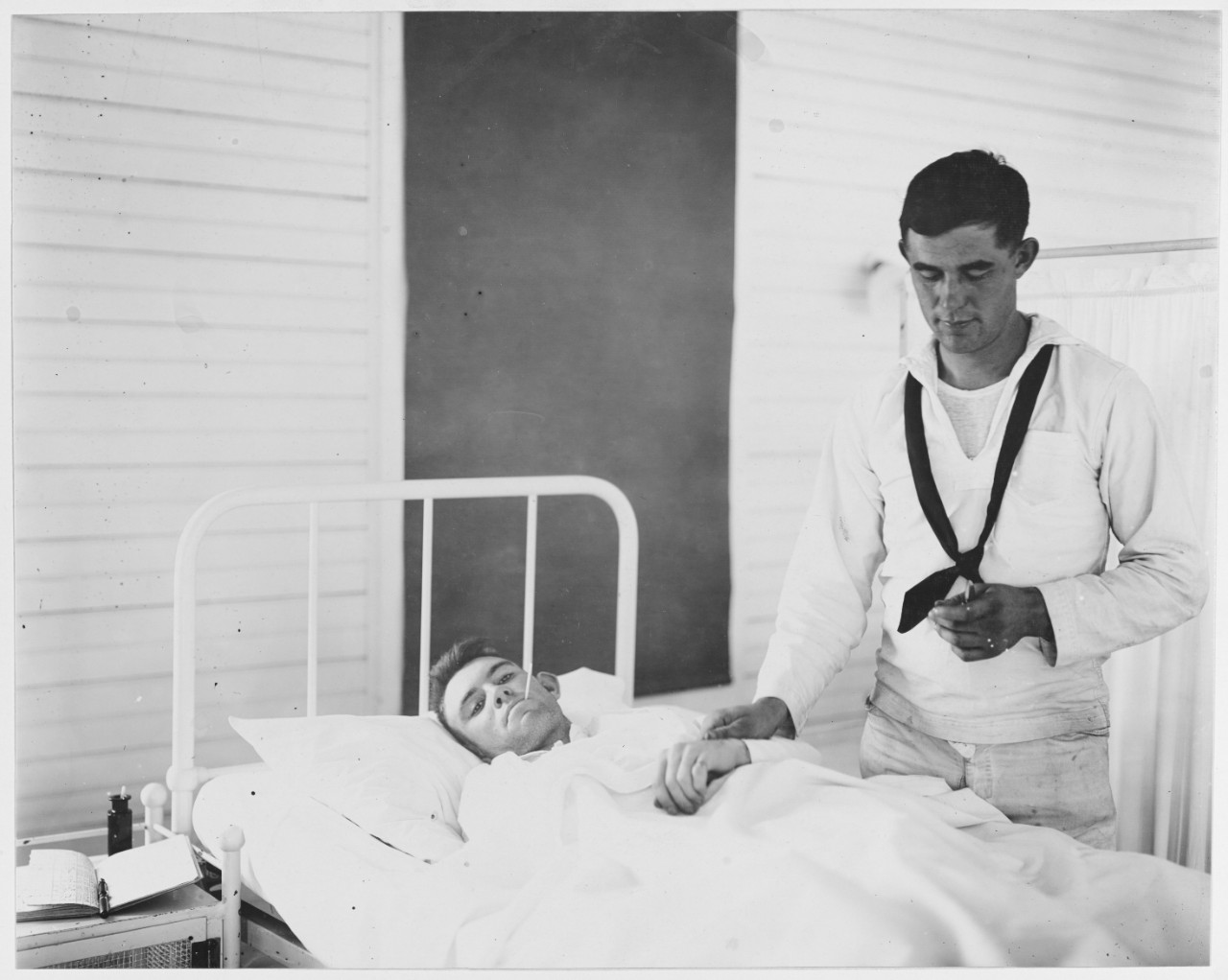 Taking pulse and temperature of patient. U.S. Naval Hospital, New Orleans, Louisiana.