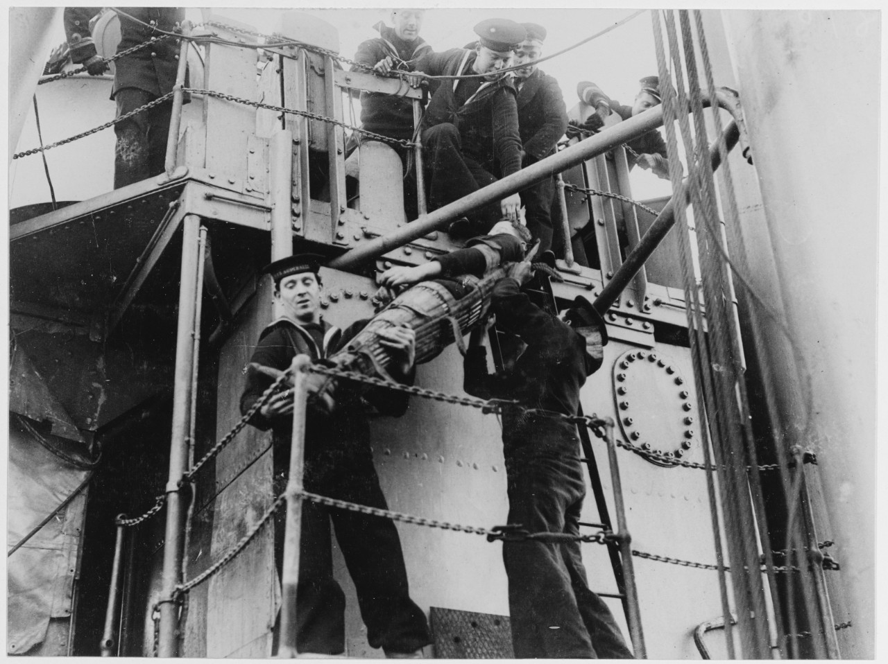 Removing wounded man from difficult position in superstructure. H.M.A.S. AUSTRALIA
