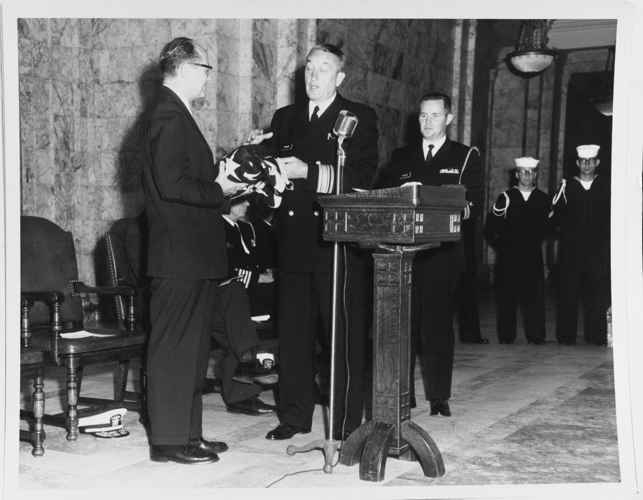Rear Admiral Towner presenting the flag from Battleship USS WASHINGTON (BB-56) to Governor Rosseleni