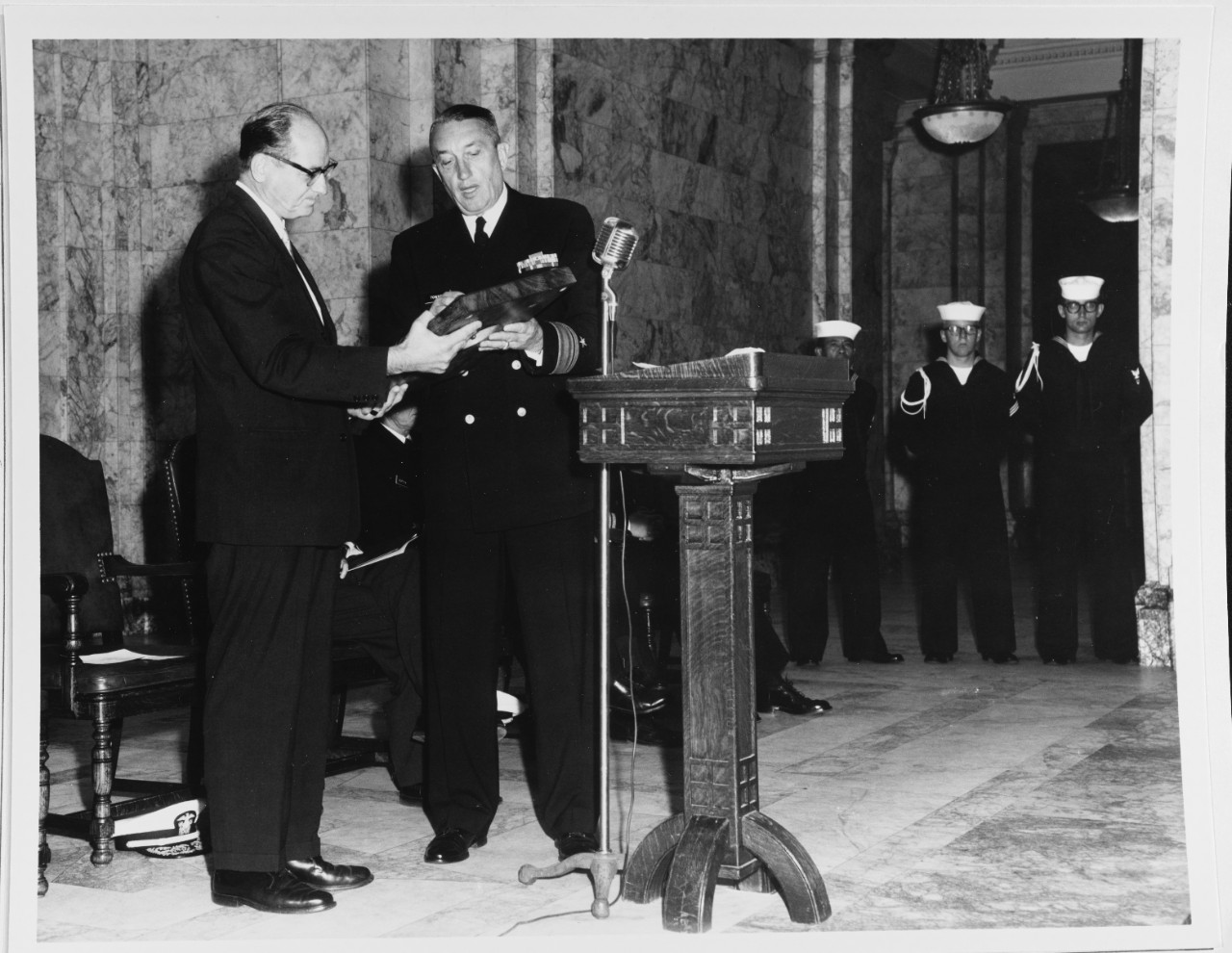 Rear Admiral Towner presenting a plaque to Governor Rosseleni at Memorial of Battleship USS WASHINGTON (BB-56)
