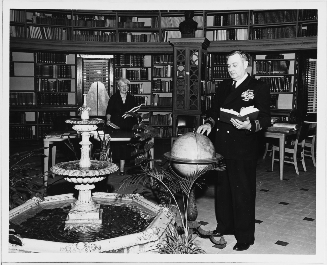 Library at U.S. Naval Observatory, March 1958. Librarian Miss Helene M. Gingras, and Communications Officer Lieutenant Commander Edward R. Rollins