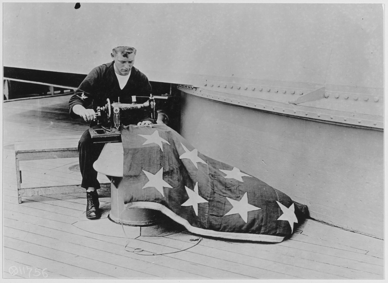 A Quartermaster Repairing The Flag