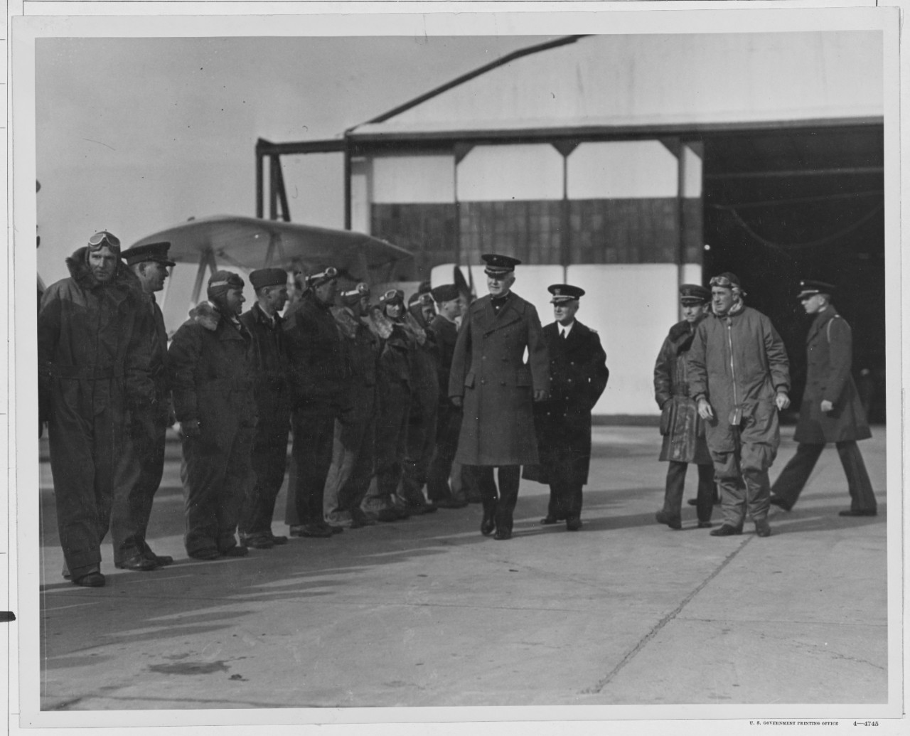Fuller B. H. Major General, comdt. USMC. Rear Admiral WM. A. Moffett, USN., receiving Marine aviators