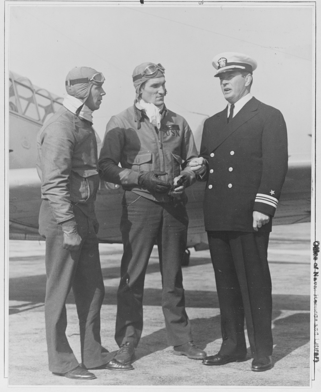 Lt. Comdr. J. J. (Gene) Tunney the Navy new athletic director, talking to cadets B.T. rude and D.M. Harmon at the Naval Air Station, Pensacola Fla.