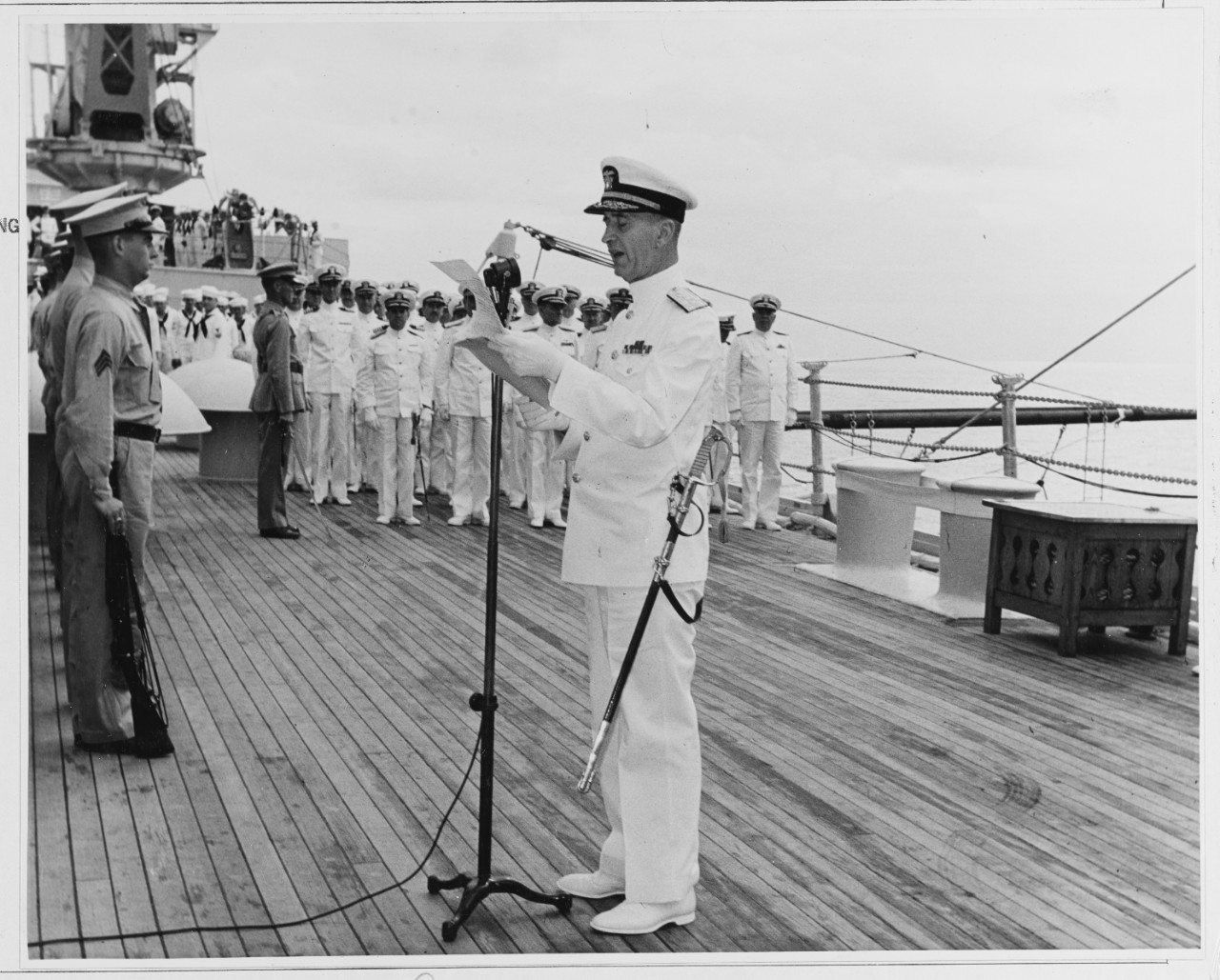 Admiral Ernest King reading orders designating him C. in C. of the U.S. ATLANTIC Fleet aboard the USS TEXAS. (BB-35)