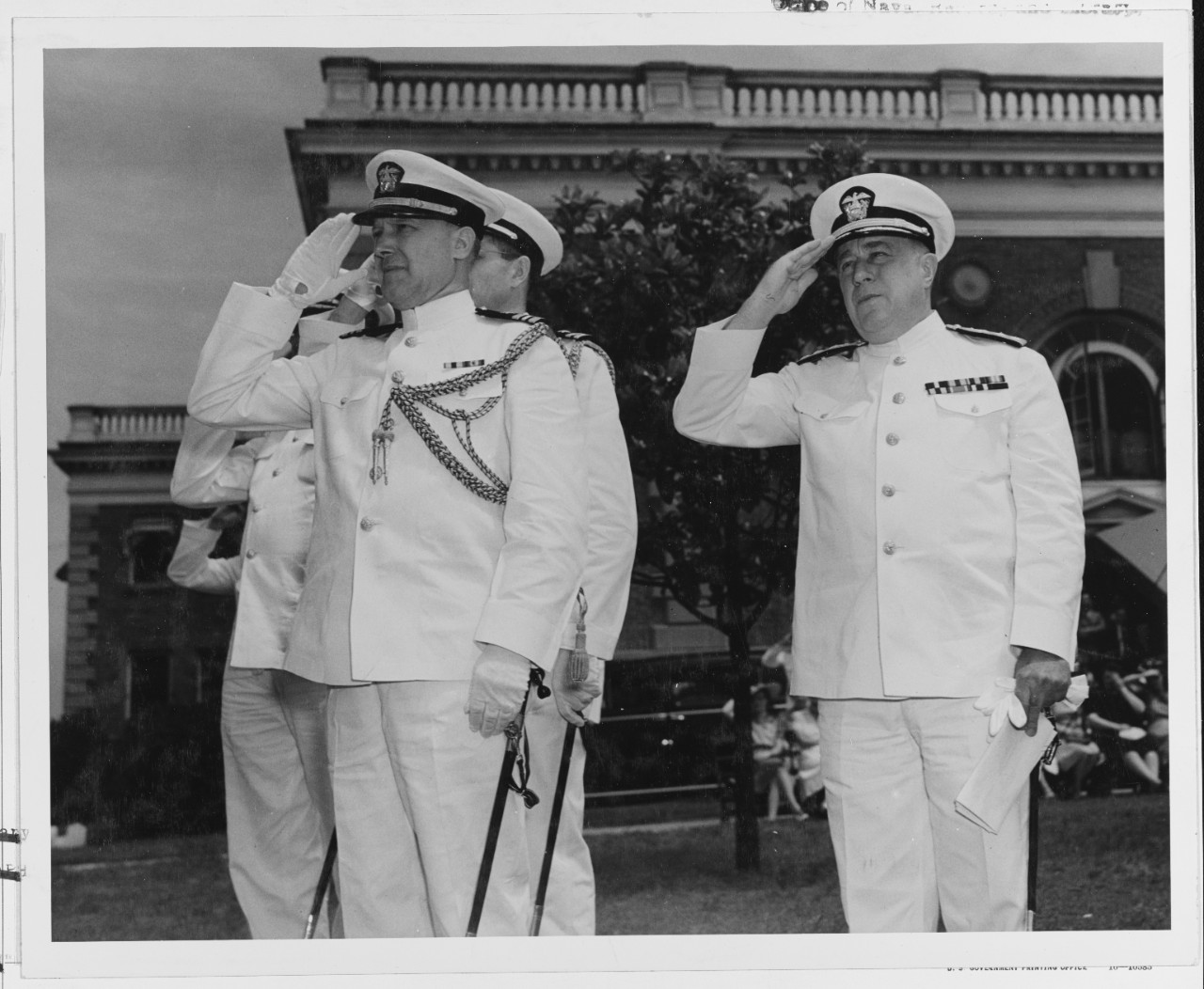 Rear Admiral Manley H. Simons, USN, at right salutes during ceremonies.