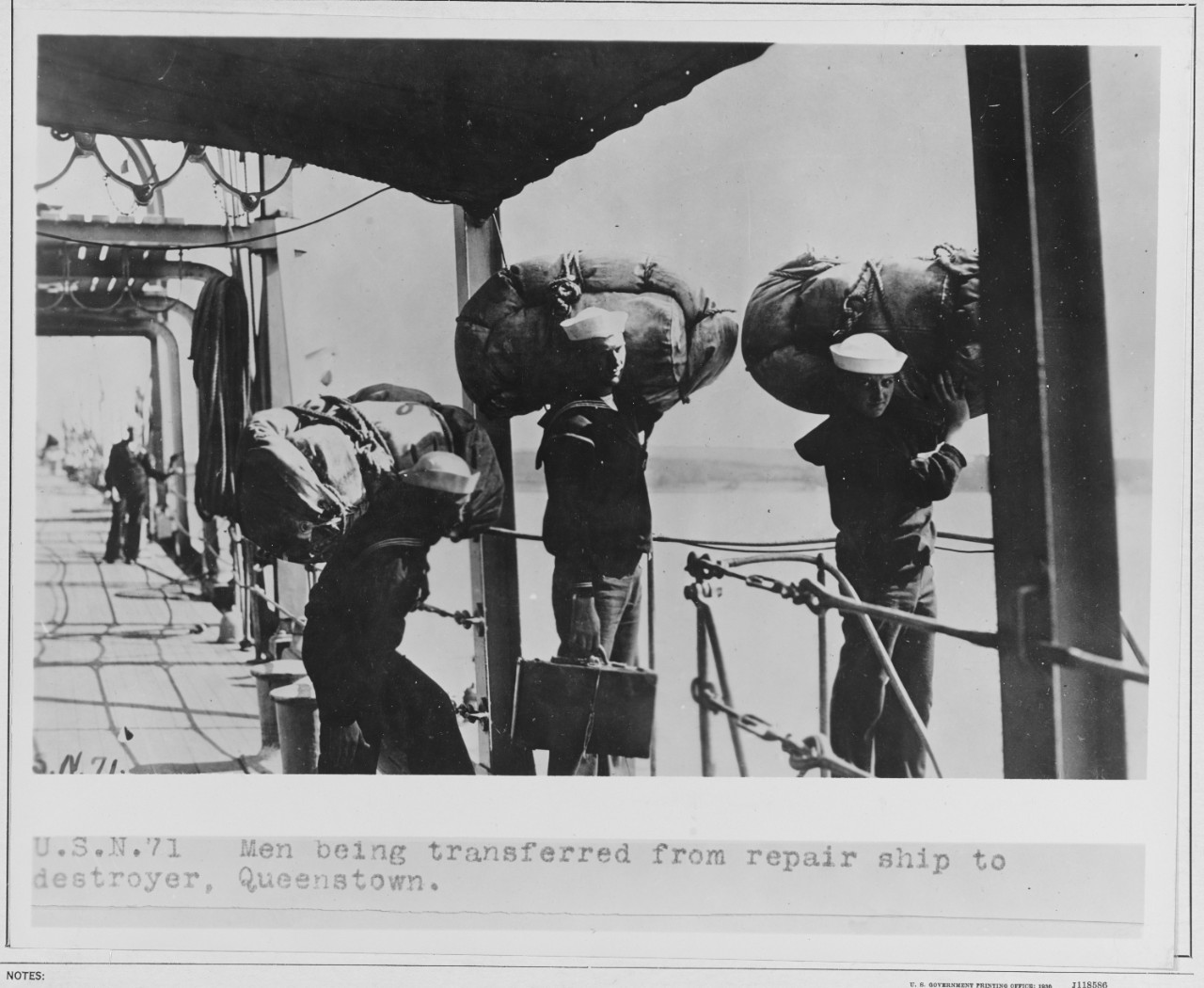 Men being transferred from repair ship to destroyer. 1918