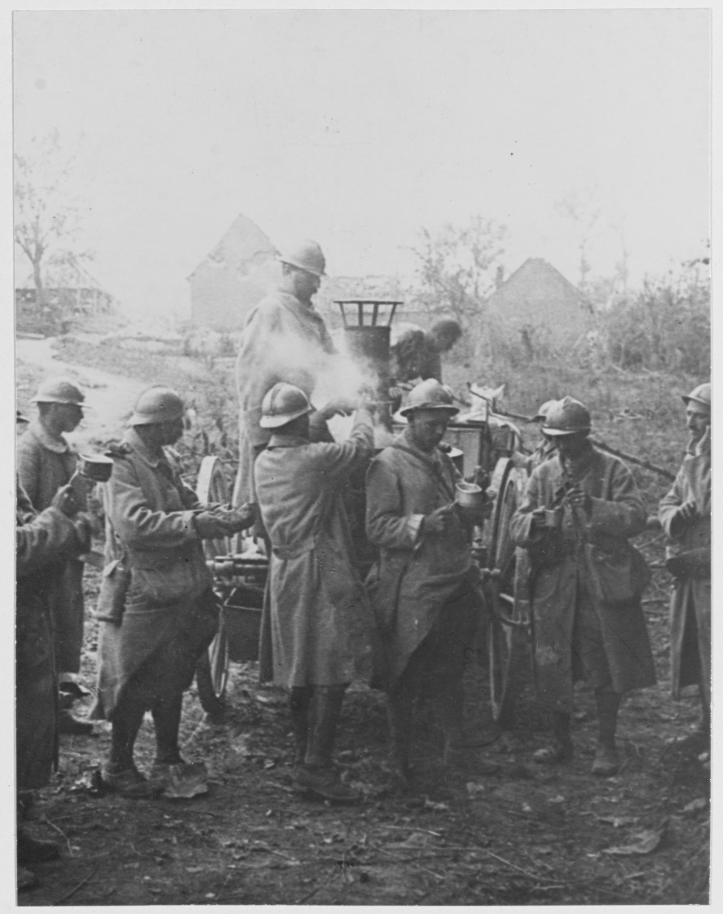 Men serving refreshments from a movable kitchen in ruined Curlu, France on the Somme, during World War I