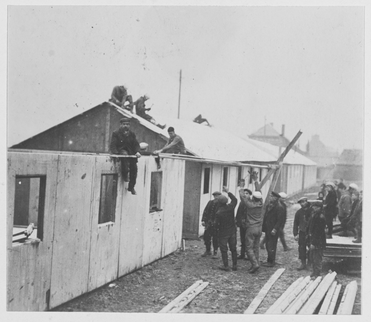 Navy relief work near Lille, France during World War I. Men constructing building and building roof