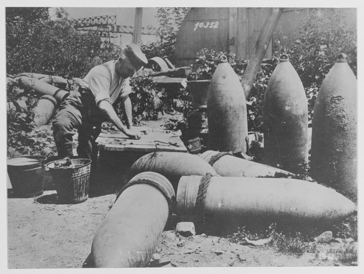 German railroad soldiers washing clothes among 30.5 in shells
