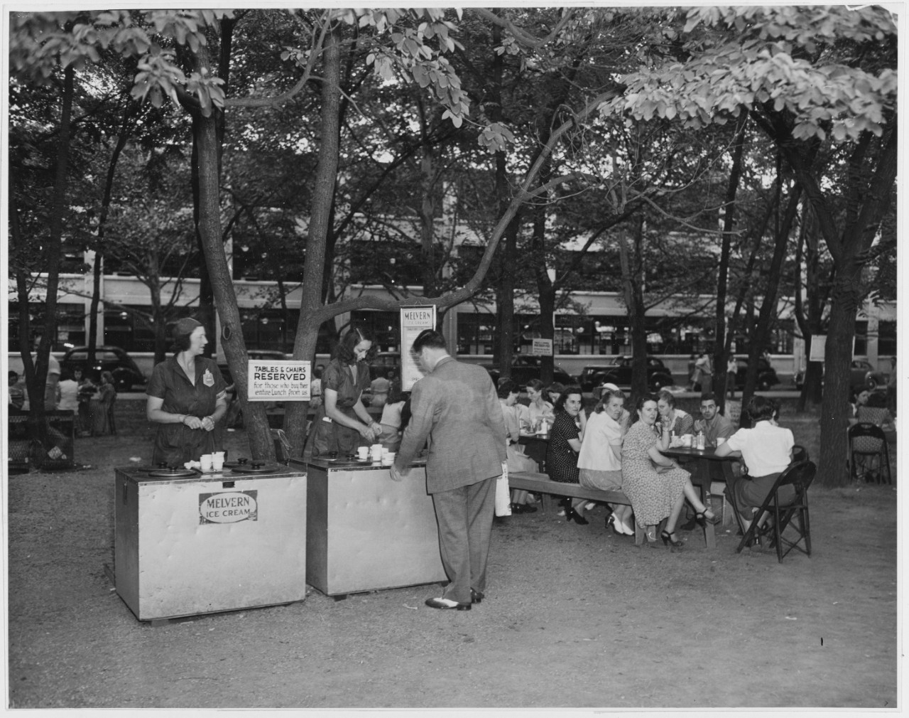 Women serving ice cream at outdoor cafeteria, people seated eating lunch, Washington, DC