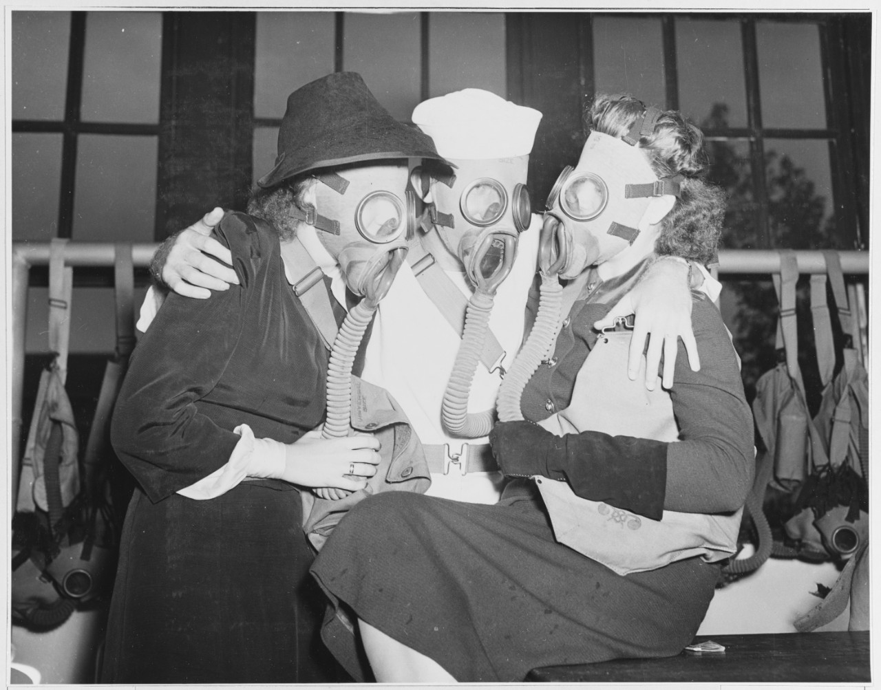 Women wear gas masks at press and radio tour of Naval Training Station, Norfolk,  October 10, 1941