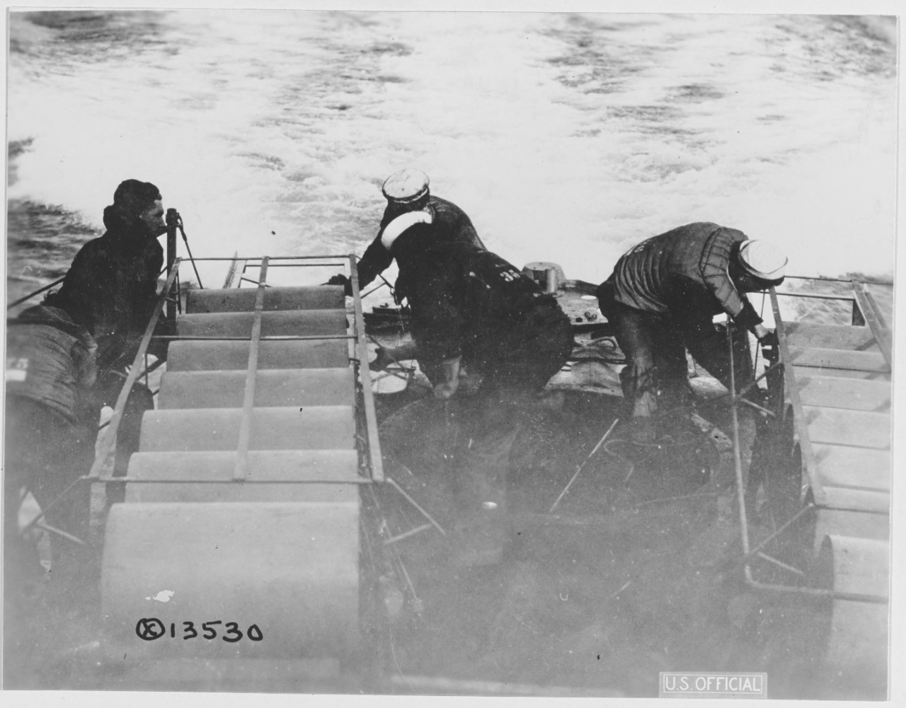 Untying depth bombs at sea on USS WHIPPLE. June 18, 1918