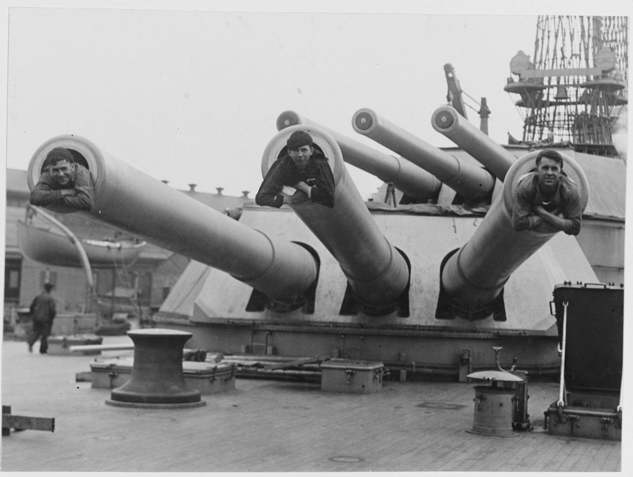 Three Jackies looking out of the 14 inch guns of the USS IDAHO (BB-42), April 10, 1919