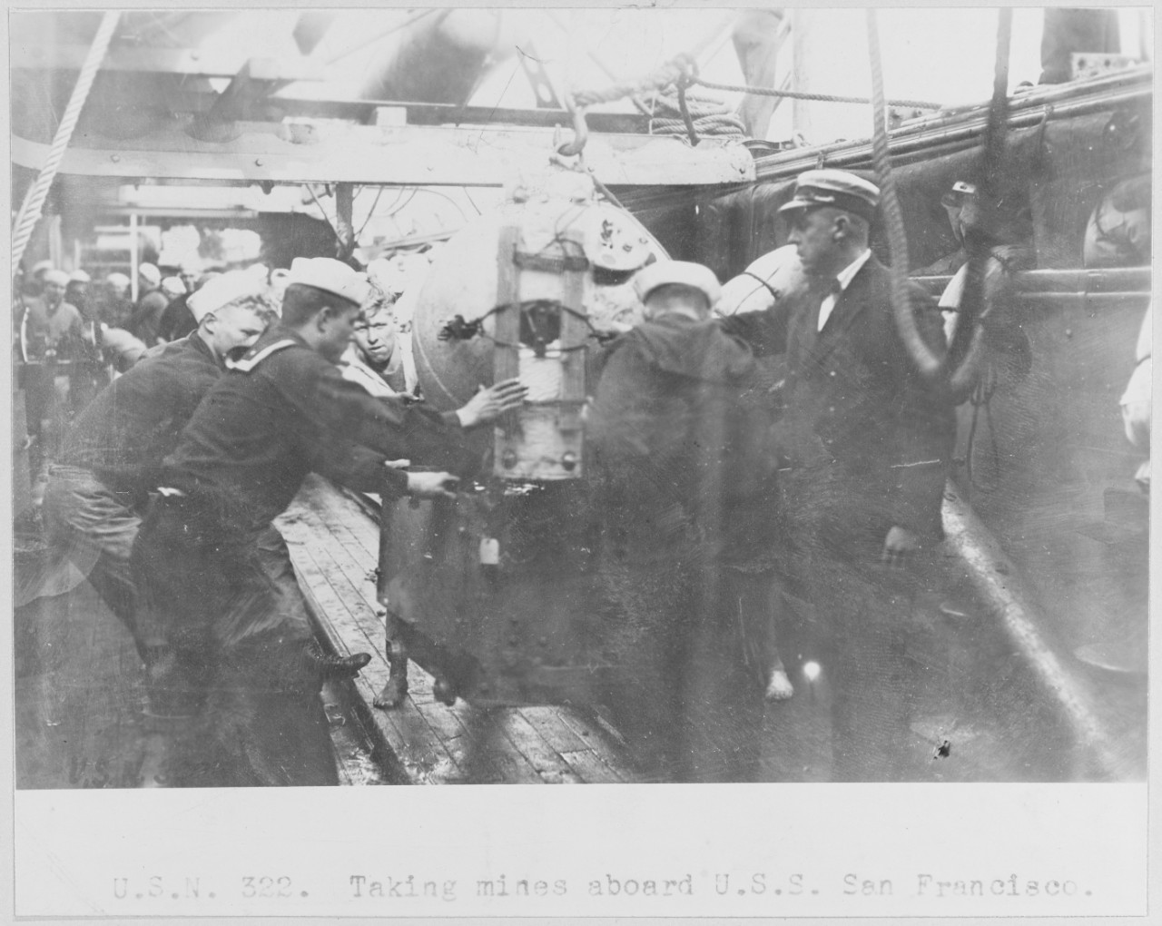 Taking mines aboard USS SAN FRANCISCO. USN 322