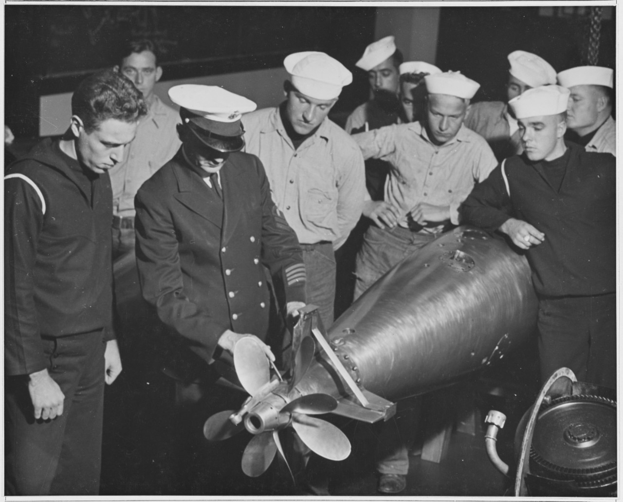 Men stand around a Torpedo. May 7, 1941