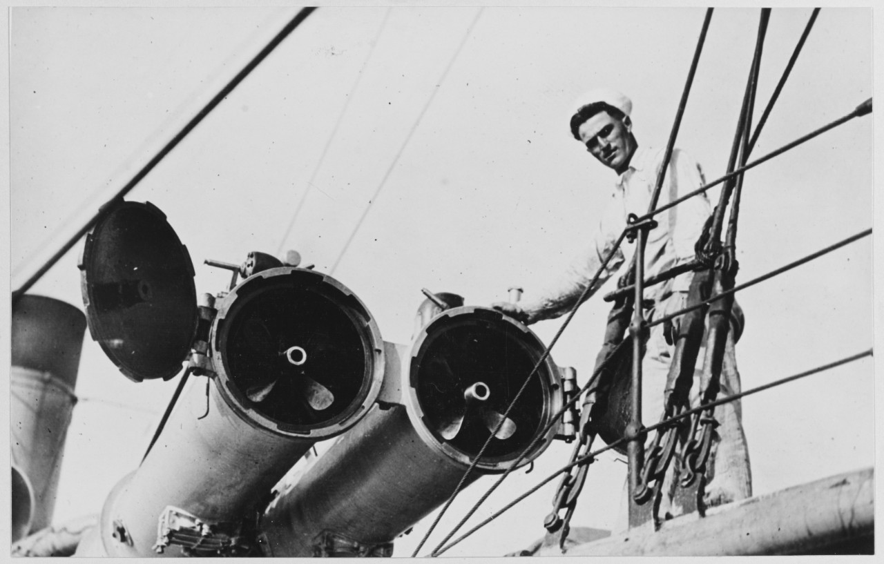 Man stands next to Torpedo tubes on the Destroyer ISABEL