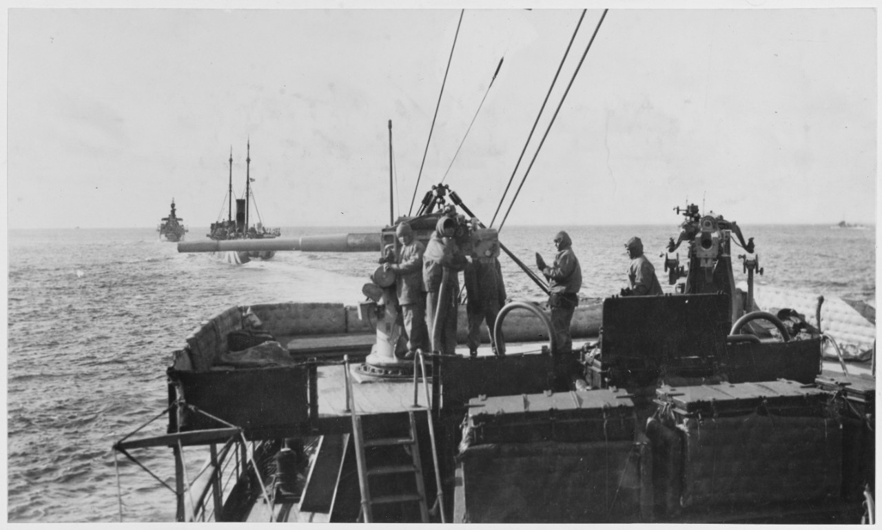 Scene on board the USS SACRAMENTO, showing the gun crew in wind-proof uniforms.