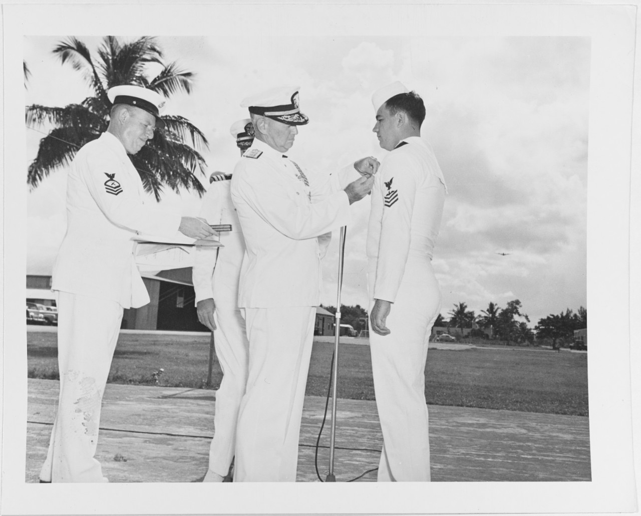 Commo. H.H.J. Benson decorates as sailor late in World War II.