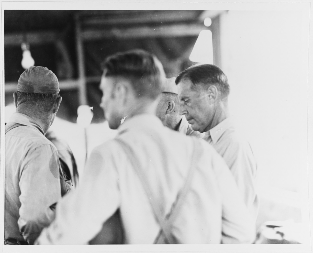 After the U.S. Marines had taken Betio Island, Tarawa Atoll, ADM C.W. Nimitz, Cincpac, inspected the island. Shown here at Headquarters are Capt. Tate (back to camera) and VADM R.A. Spruance, ComFifthFleet, 27 Nov. 1943.