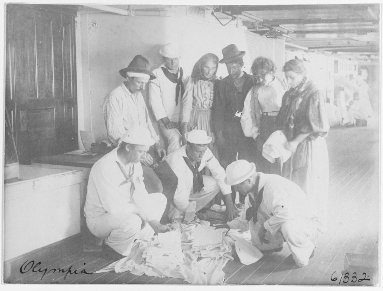 USS OLYMPIA (C-6), peddlers selling clothing to crewmen, 1898. 