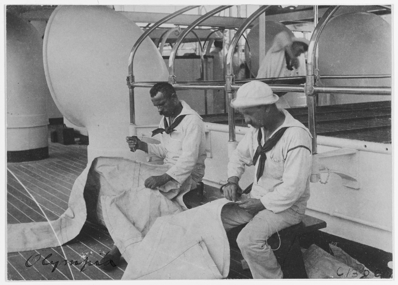 USS OLYMPIA (C-6), sailmakers at work, 1898. 
