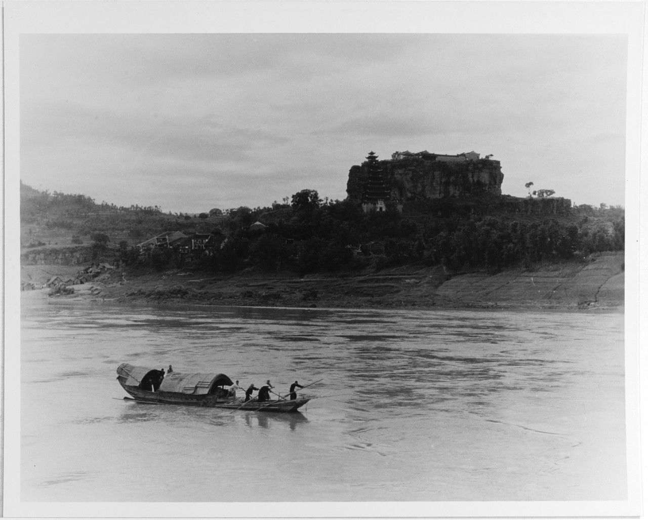 View of a junk passing a temple on the Upper Yangtze River, China, circa 1934