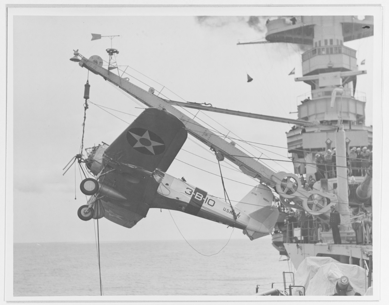 USS SARATOGA (CV-3) hanging a plane from its crane
