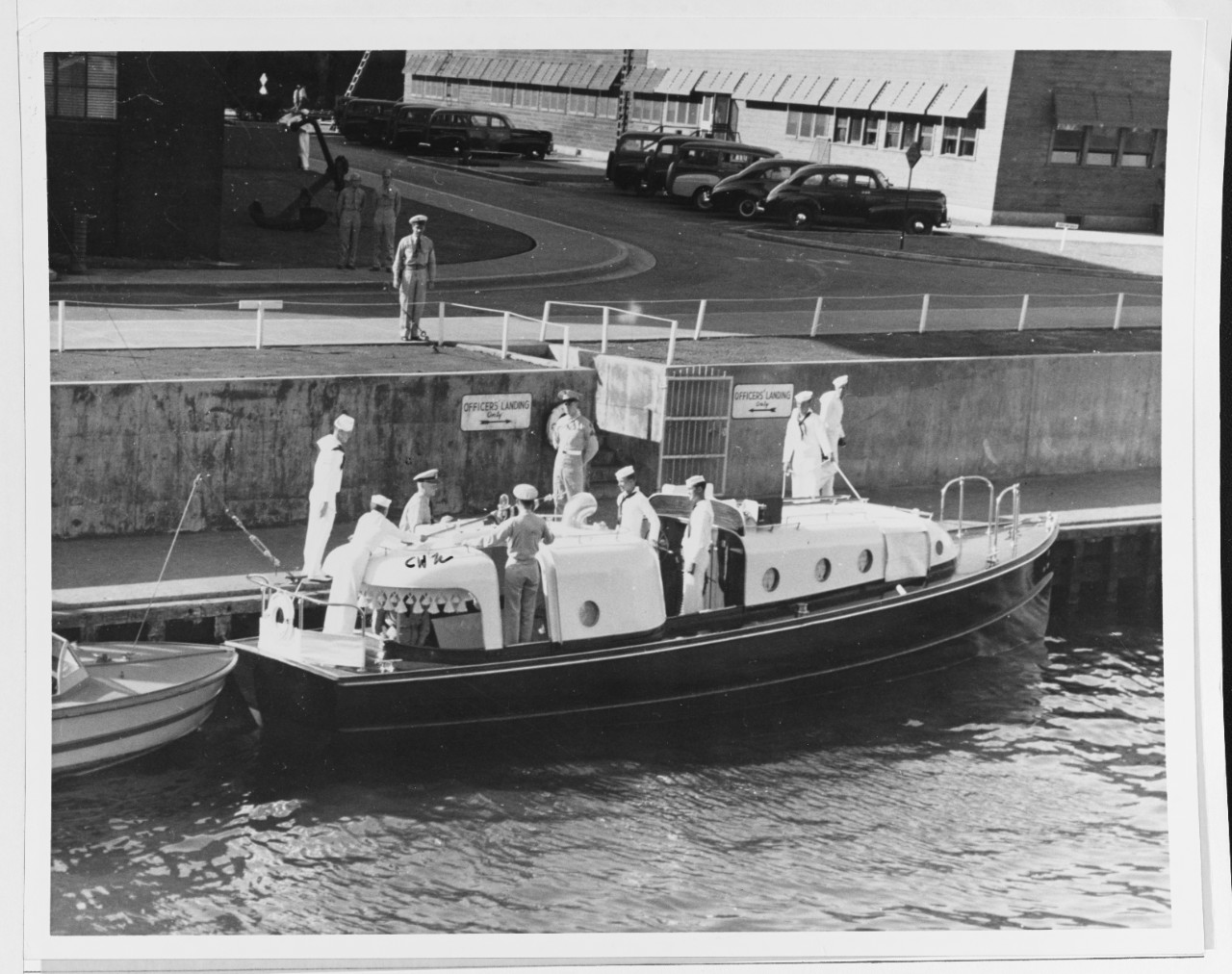 Fleet Admiral Chester W. Nimitz, USN, CinCPac-POA, leaves his barge at Pearl Harbor.