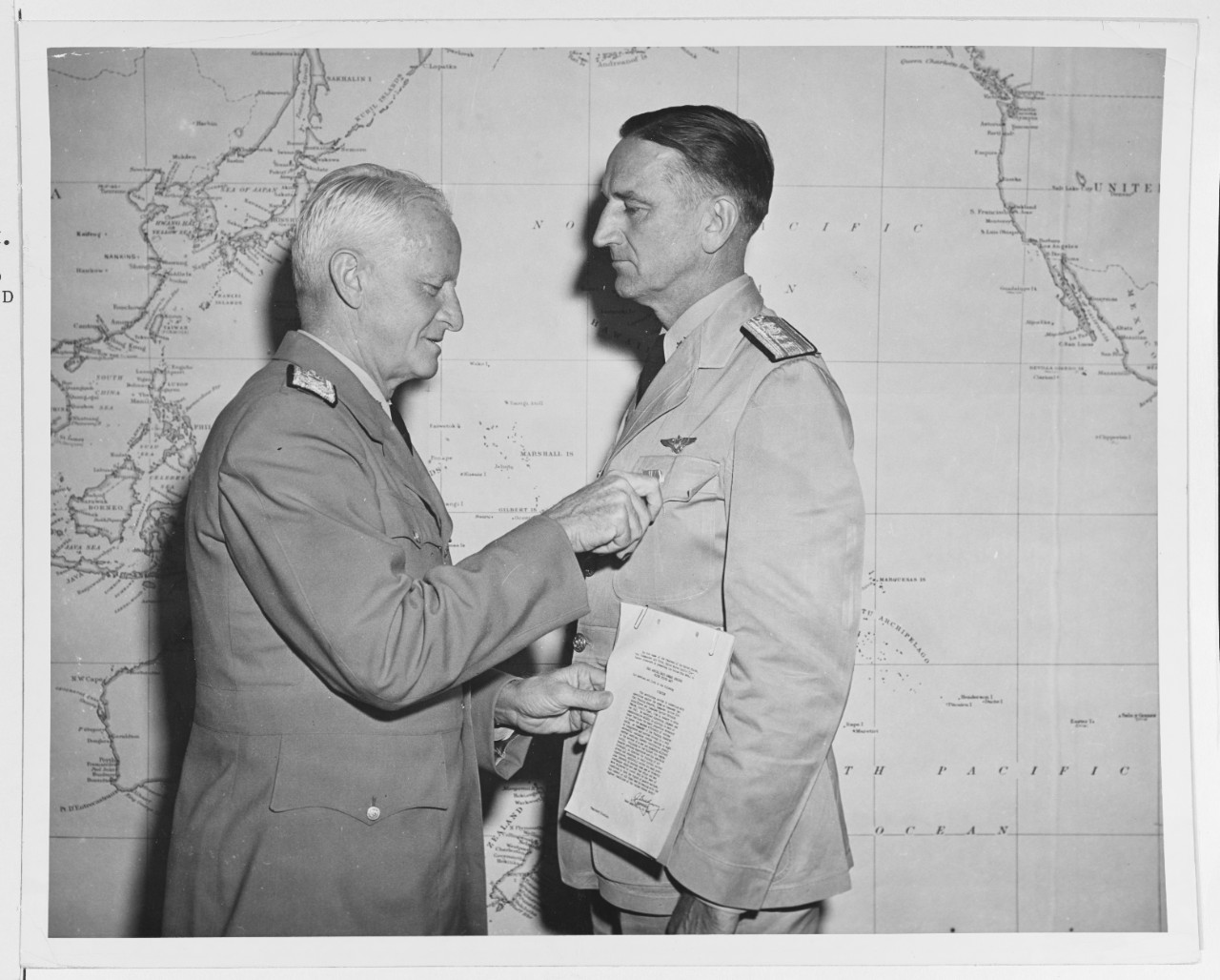 Fleet Admiral Chester W. Nimitz (CinCPac-POA) presents the Bronze Star to Rear Admiral Ralph E. Jennings, USN.