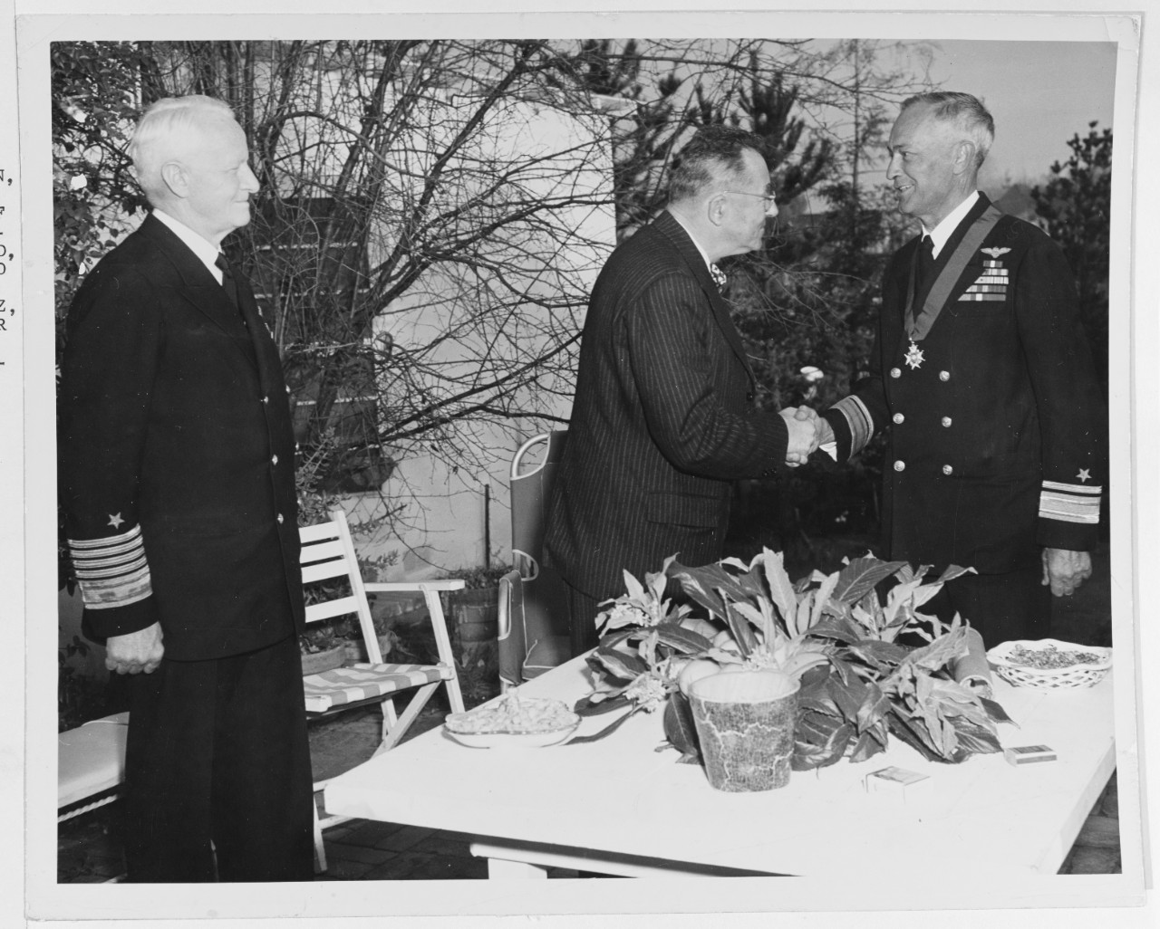 Rear Admiral Ernest L. Gunther, USN, was presented the insignia of companion of the order of the bath by Sir Carl Berendsen.