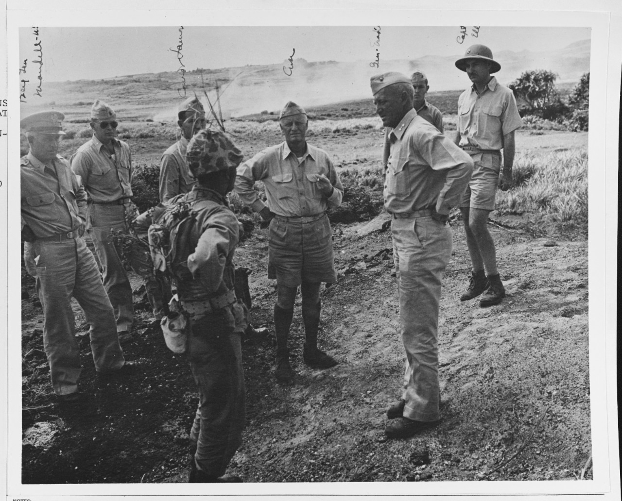 Fleet Admiral Chester W. Nimitz (CinCPac-POA) listens to a Marine explain his combat gear during World War II.