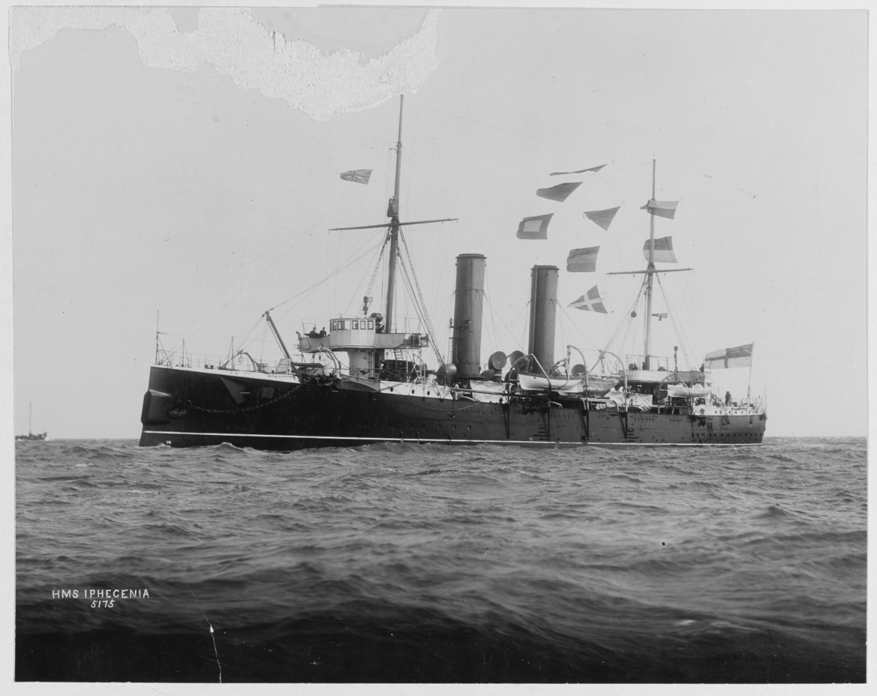 HMS IPHIGENIA (British Cruiser, 1891).  Flying signal flags